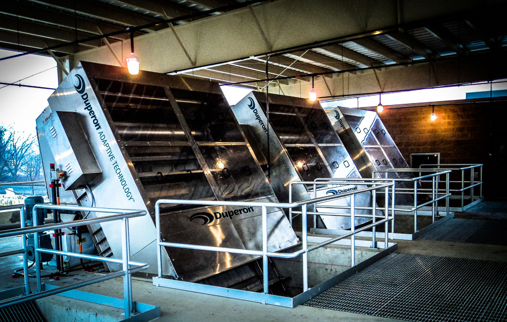 Three Duperon FlexRake bar screens installed in a covered headworks channel at a municipal wastewater treatment plant