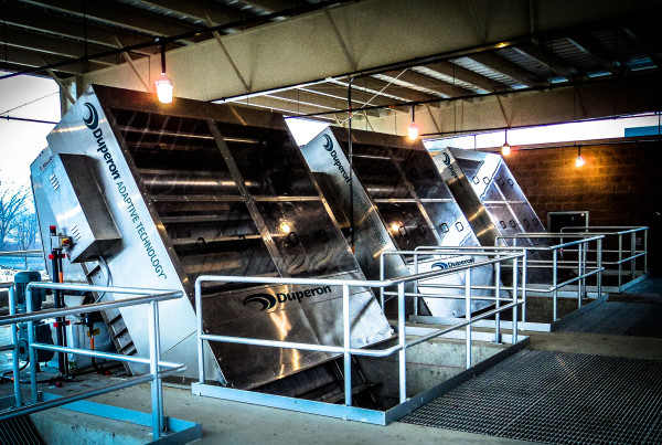 Three Duperon FlexRake bar screens installed in a covered headworks channel at a municipal wastewater treatment plant