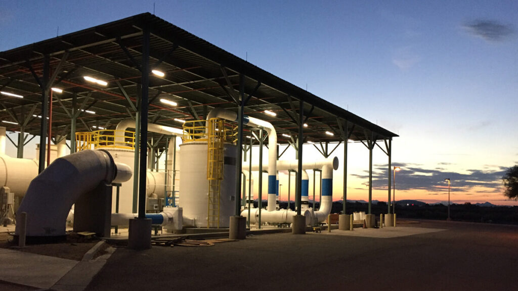 Industrial facility at dusk with pipes