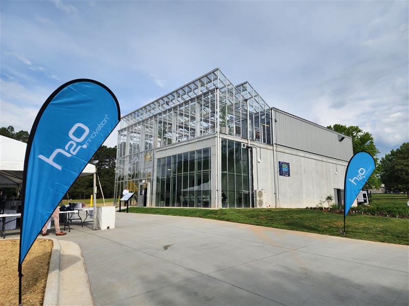 The WaterHub Approach to Sustainable Water Management in Texas H2O Innovation WaterHub treatment facility with branded banners at the entrance