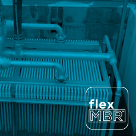 Blue-tinted photo of flexMBR flat-sheet membrane cassettes and air piping inside a membrane tank